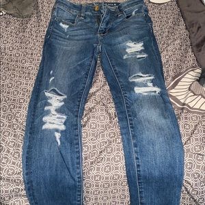 High rise light rinse AE jeans with holes 00